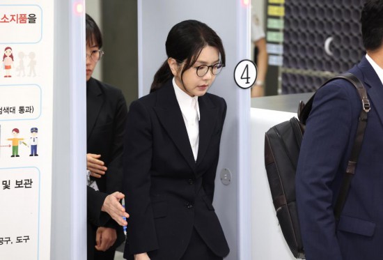 这是8月12日在韩国首尔中央地方法院拍摄的韩国前总统尹锡悦妻子金建希(中)。新华社/纽西斯通讯社